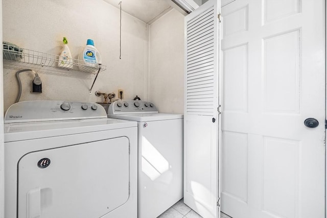 laundry area featuring light tile patterned floors, independent washer and dryer, and laundry area