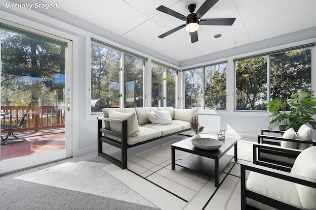 sunroom with a healthy amount of sunlight and ceiling fan