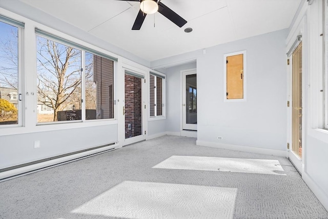 unfurnished sunroom with a baseboard heating unit and a ceiling fan