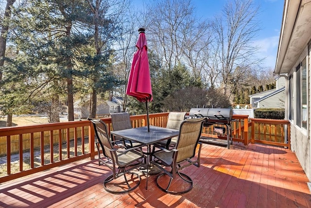 deck with outdoor dining area and a grill