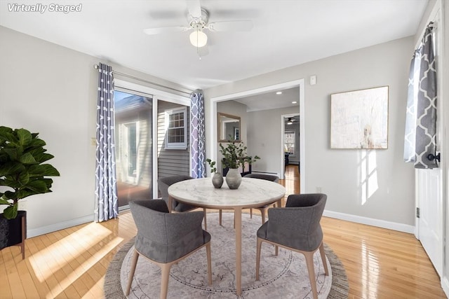 dining room with light wood-type flooring, baseboards, and ceiling fan