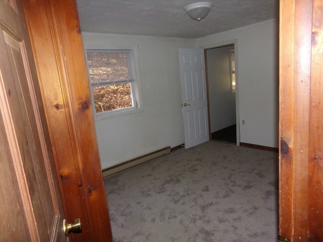 interior space with a baseboard radiator and carpet