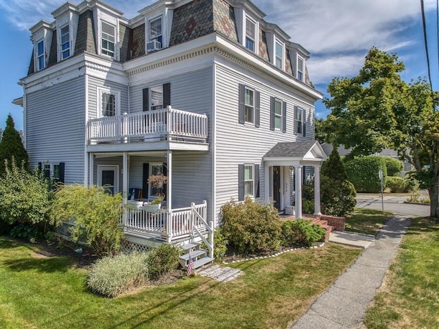 38 Moseley Ave Unit 5, Newburyport, MA 01950 - view of side of home with a balcony, mansard roof, a lawn, and a porch