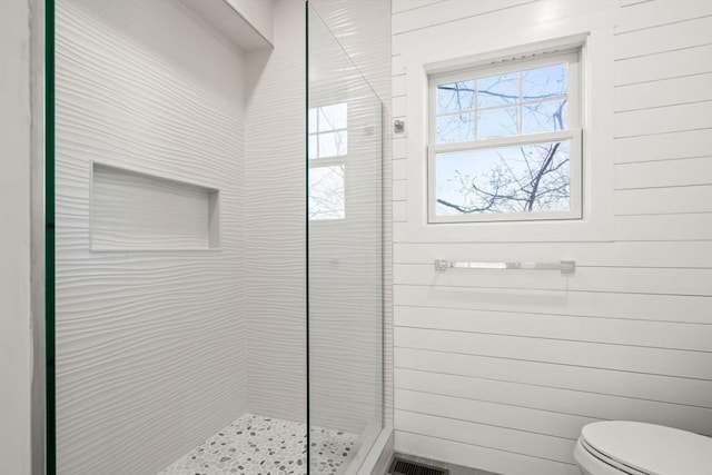 full bathroom featuring toilet, visible vents, and a stall shower