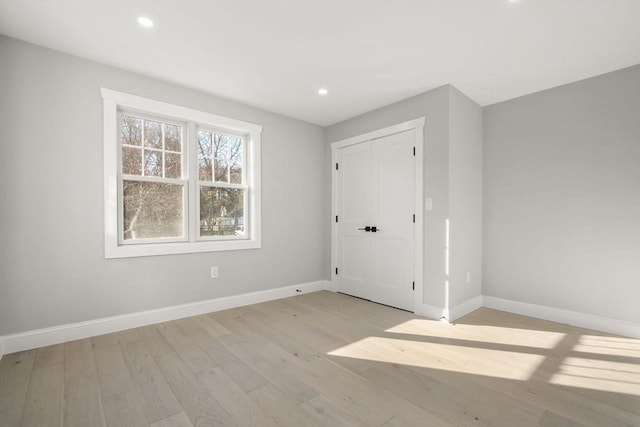 interior space featuring recessed lighting, light wood-style flooring, and baseboards