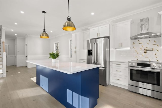 kitchen featuring a center island, crown molding, light wood-style flooring, wall chimney exhaust hood, and appliances with stainless steel finishes