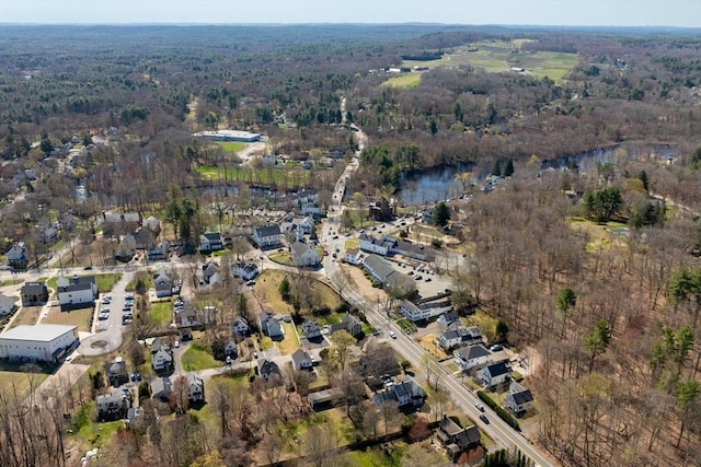 bird's eye view with a wooded view