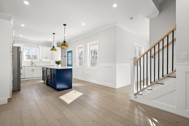 kitchen with recessed lighting, freestanding refrigerator, a center island, and white cabinetry