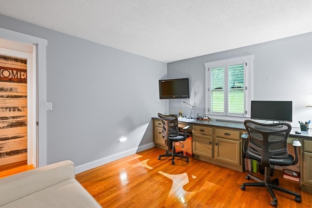home office featuring light wood-style flooring and a textured ceiling
