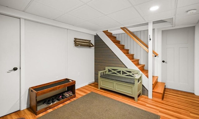 finished below grade area featuring light wood-style flooring, stairway, and recessed lighting
