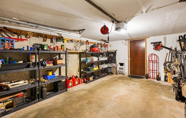 garage with a garage door opener and a workshop area