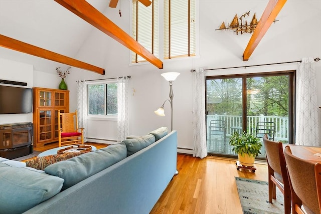 living room with high vaulted ceiling, beam ceiling, light wood-type flooring, a ceiling fan, and a baseboard heating unit