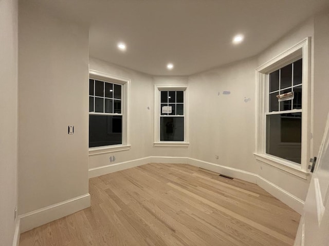 spare room featuring light wood-style flooring, recessed lighting, baseboards, and visible vents