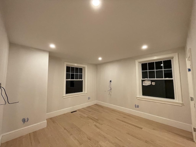 spare room featuring recessed lighting, visible vents, light wood-style flooring, and baseboards