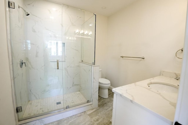 bathroom featuring a marble finish shower, toilet, and vanity