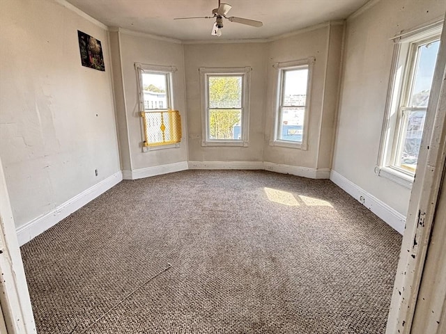 unfurnished room featuring carpet flooring, ornamental molding, ceiling fan, and baseboards