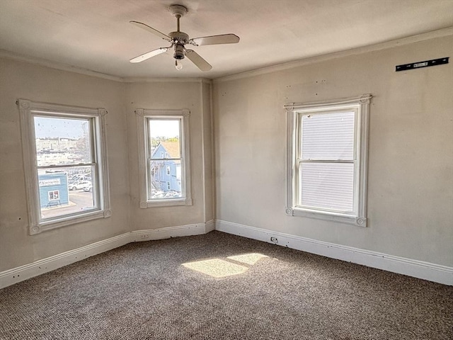 unfurnished room with ornamental molding, carpet flooring, ceiling fan, and baseboards