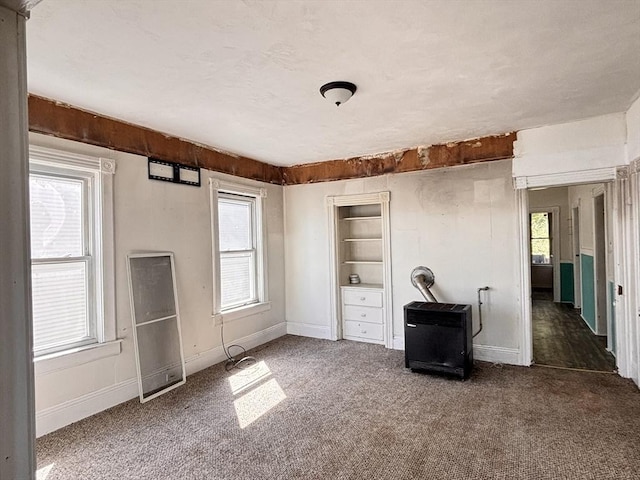 unfurnished bedroom featuring carpet flooring and baseboards