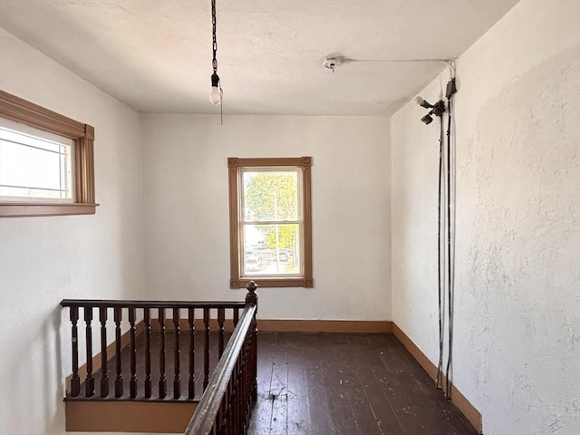 stairs with hardwood / wood-style floors and baseboards