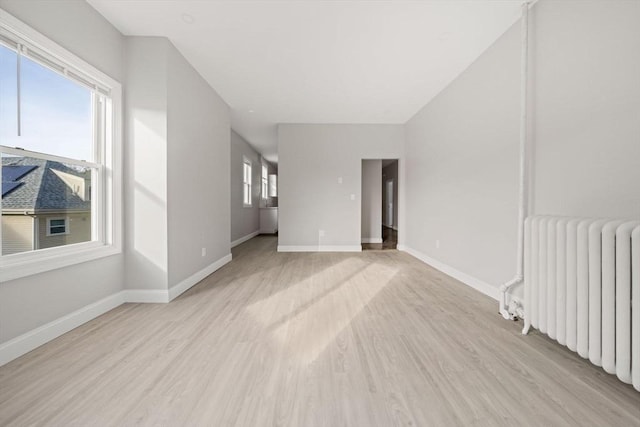 17 Magnolia Sq, Boston, MA 02125 - empty room featuring radiator, light wood-type flooring, and baseboards