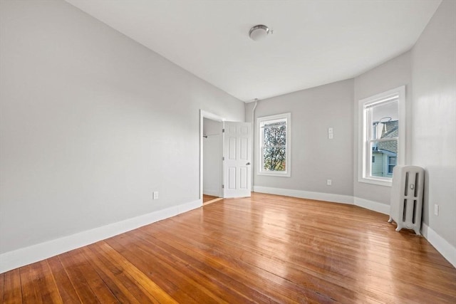 17 Magnolia Sq, Boston, MA 02125 - spare room featuring radiator heating unit, baseboards, and wood finished floors