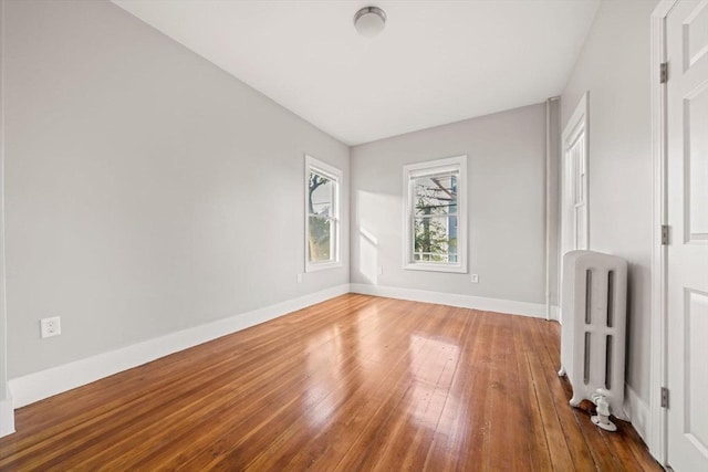 17 Magnolia Sq, Boston, MA 02125 - unfurnished bedroom with radiator, hardwood / wood-style flooring, and baseboards