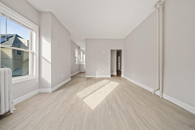 17 Magnolia Sq, Boston, MA 02125 - unfurnished room featuring light wood-style floors, radiator, and baseboards