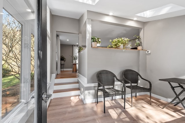 interior space featuring a skylight and light wood-type flooring