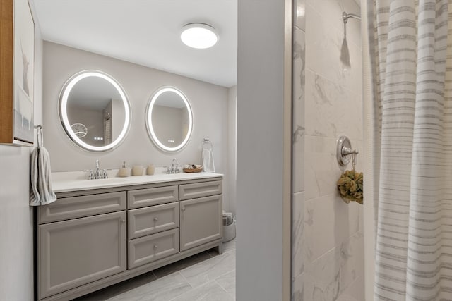 bathroom with vanity and tiled shower