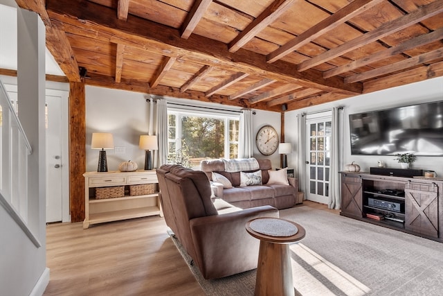 living room with beam ceiling, light wood-type flooring, and wooden ceiling