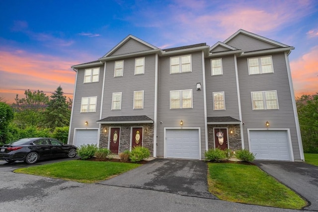 2 Heron Way Unit B, Salisbury, MA 01952 - view of property featuring driveway, stone siding, a garage, and a front lawn