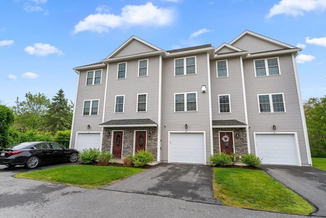 2 Heron Way Unit B, Salisbury, MA 01952 - townhome / multi-family property with driveway, stone siding, a front lawn, and a garage