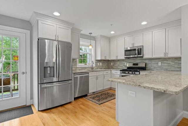 2 Heron Way Unit B, Salisbury, MA 01952 - kitchen featuring appliances with stainless steel finishes, a peninsula, white cabinetry, light wood-type flooring, and recessed lighting