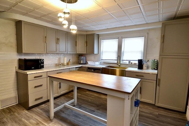 kitchen with dark hardwood / wood-style flooring, decorative light fixtures, sink, wood counters, and decorative backsplash