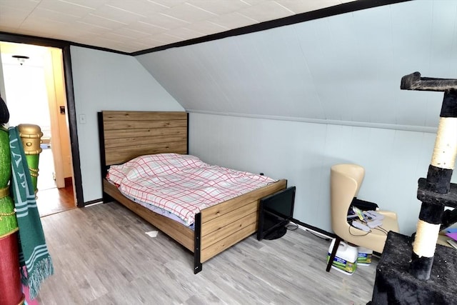 bedroom featuring vaulted ceiling and hardwood / wood-style floors