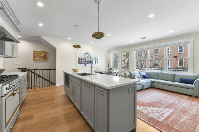 440 Cambridge St Unit 2, Cambridge, MA 02141 - kitchen featuring gray cabinets, a sink, white gas range, light countertops, and stainless steel microwave