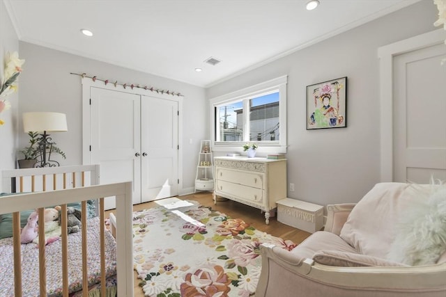 440 Cambridge St Unit 2, Cambridge, MA 02141 - bedroom with wood finished floors, crown molding, a closet, and recessed lighting