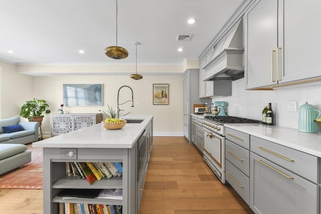 440 Cambridge St Unit 2, Cambridge, MA 02141 - kitchen with gray cabinets, double oven range, open shelves, a sink, and ornamental molding