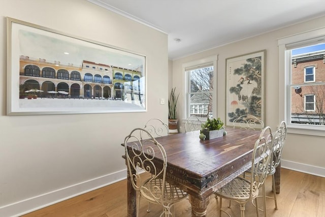 440 Cambridge St Unit 2, Cambridge, MA 02141 - dining area featuring crown molding, wood finished floors, baseboards, and plenty of natural light