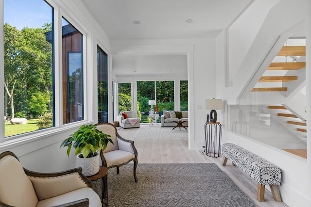 sunroom / solarium with plenty of natural light and wood finished floors