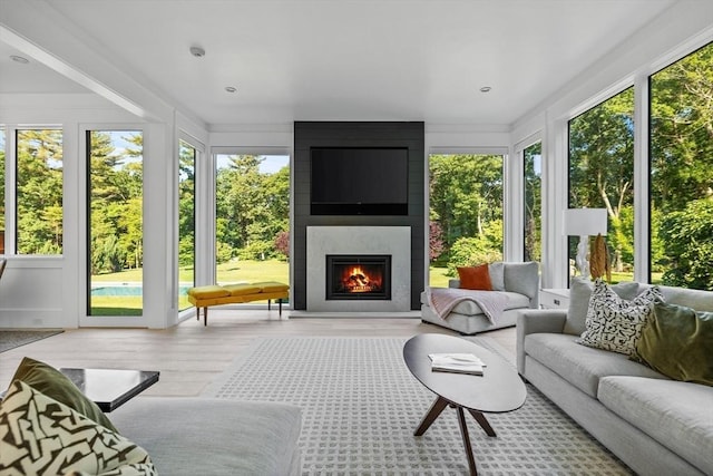 sunroom / solarium featuring plenty of natural light and wood finished floors