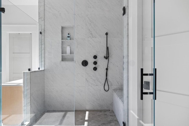full bath with tiled shower