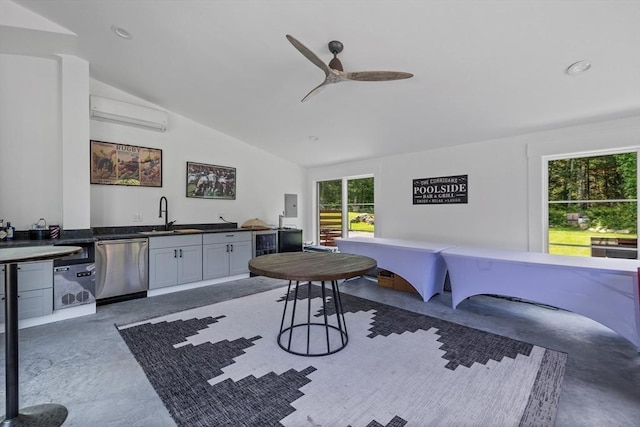 dining space with vaulted ceiling, finished concrete floors, a wall mounted AC, and ceiling fan