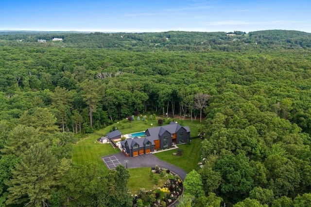 bird's eye view with a wooded view