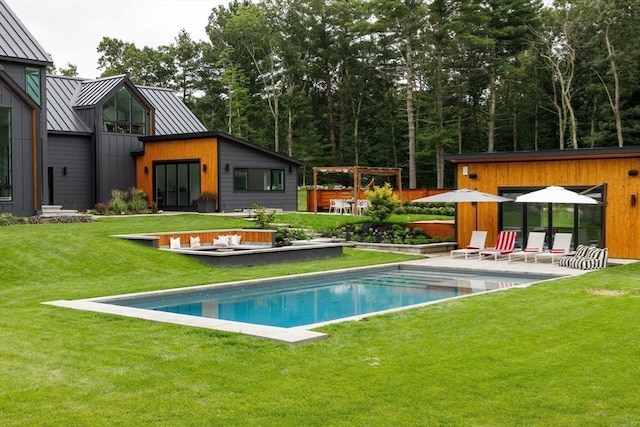 outdoor pool with a patio and a lawn
