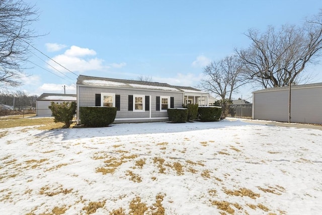 view of snow covered rear of property