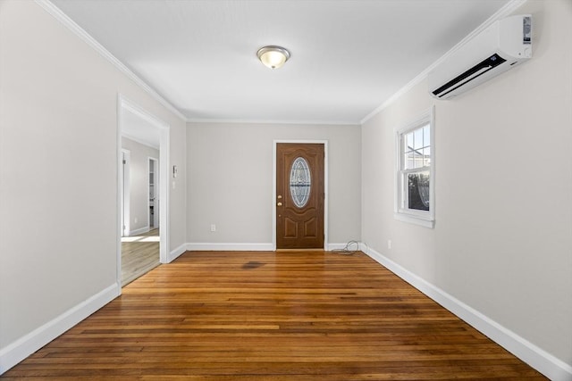 foyer featuring ornamental molding, hardwood / wood-style floors, and an AC wall unit