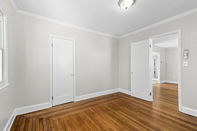 spare room featuring crown molding and wood-type flooring