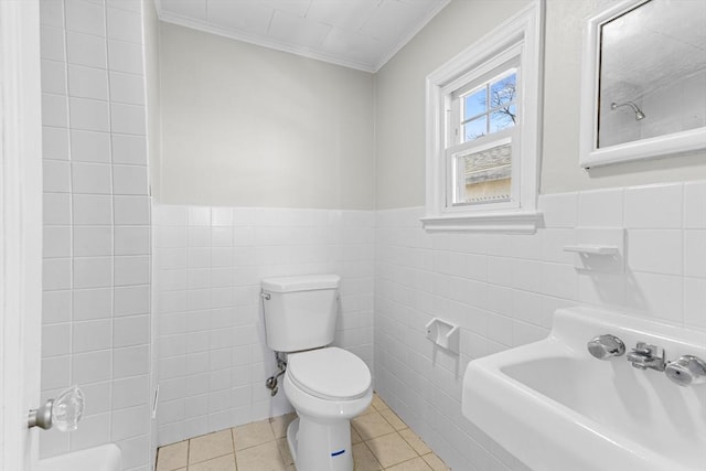 bathroom featuring tile patterned flooring, ornamental molding, sink, and tile walls