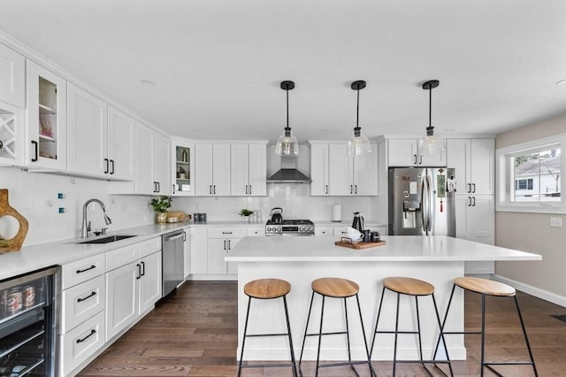 kitchen with appliances with stainless steel finishes, a center island, wine cooler, and sink